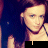 A static image of a person with long brown hair wearing a dark sleeveless top, displayed in a with text overlays changing across frames