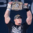 A person holds a championship belt above their head against a dark background, with pink text reading "I LOVE JOHN CENA!!" on a pink background.