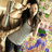 Pixelated static image of a person in dark clothing holding an object against a blurred background with mixed colors.