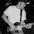 Black-and-white animated sequence showing a person playing guitar, with text overlay reading 'stretch arm strong doing it for the ...kids!'