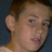 A pixelated image of a person with short brown hair, showing two side-by-side views with slight head movement and text overlay.