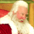 Static 50x50 pixel icon of a cartoon Santa Claus figure with white hair and beard, wearing red and white clothing against a blurred background.