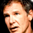 Static 48x48 pixel icon showing a close-up of a person's face with brown hair and light skin tone against dark background.