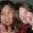 Two pixelated figures with light skin tones and dark hair, one wearing a red garment, against a muted background.