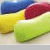 Pixelated image of three colorful pillows with blue, red, and green sections on a light surface.