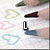 six shows a hand holding a brown object over heart-shaped outlines, with text changing from 'L' to 'Liz', then 'Lizz', and finally 'Lizzy.'