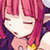 Pixelated static image of a character with pink hair and closed eyes, wearing dark clothing with yellow accents.