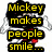 Mickey Mouse figure in red shorts and yellow shoes stands with arms outstretched above a puzzle piece ribbon symbol, surrounded by text about autism awareness.