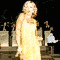 animated frames showing a woman in a yellow dress performing various poses and expressions against a dark background with blurred figures