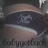 A circular icon with a dark blue band containing a white horse silhouette, bordered by light brown and gray stripes. The text "babygirl" appears below the circle.