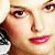 Pixelated close-up of a person's face showing eyes, nose, lips with pink lipstick, and part of dark hair against light background.
