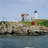 Pixelated landscape image of a lighthouse on a rocky shore with text labels on blue and gray