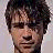 A pixelated contact sheet of two frames showing a person's face and the text "Colin Farrell" in bold black letters on white background.