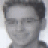 Pixelated grayscale portrait of a person with short dark hair and closed eyes, rendered in low-resolution 48x48 pixels with visible dithering and anti-aliasing artifacts.