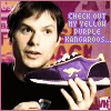A person holds a purple shoe with a yellow kangaroo logo, then holds a blue object while the shoe remains visible.