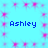 A static image with a light blue background featuring four instances of the name 'Ashley' in dark blue pixelated text, surrounded by pink starburst patterns.