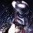 Pixelated static image of a humanoid figure in dark clothing with glowing white accents against a black background, appearing to hold an object near its face.