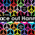 A colorful pixelated pattern of repeating geometric shapes with a black background and partially visible text reading "ore out Honn".