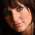 Two side-by-side frames of a low-resolution animated icon showing a woman with dark hair in different poses against a black background.