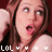 nine identical pixelated images showing a person with long brown hair, wearing headphones and holding an arm near the head against a dark red background