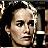 Pixelated static image of a person's face with dark hair and light skin tones, rendered in low-resolution 256x256 pixels with visible dithering and blocky artifacts.