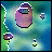 Pixelated animation of a purple circular shape with a small rectangular top section, surrounded by green and blue background elements and smaller purple shapes moving across the scene.