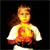 Pixelated static image of a person with long brown hair wearing a white shirt against black background, featuring prominent orange-yellow gradient on chest area.