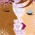 A pixelated close-up of two figures in profile facing each other, one with brown hair and the other with light skin and dark eyes, lips slightly parted.