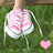 A pixelated image shows a person in a white dress with pink patterns standing on green grass, holding a small pink heart-shaped object.