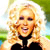 Pixelated image of a person with long blonde hair wearing a black top, smiling with mouth open, against a blurred green and blue background.