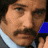 six shows a person with dark hair and mustache, wearing light blue collar, alongside yellow-blue circular '4' symbols and text elements