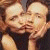 A 50x50 pixel animated contact sheet showing two frames of a David Duchovny icon with green text on the right side reading "Original Icons .com".