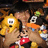 Pixelated static image shows a cartoon character with brown hair, red top, and orange accessory against dark background.