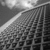 A grayscale pixelated image shows a diagonal light beam cutting across a grid-like structure with varying shades of gray.