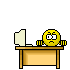 Yellow circular character with downturned mouth sits at desk, repeatedly hitting computer monitor with wooden hammer until screen shatters into pieces.