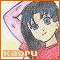 Pixelated anime-style character with dark blue hair and red top, hand behind head, smiling face on light background.