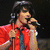 A person in a red shirt and tie holds a microphone while singing, with text reading 'I Love Joe Jonas' on a black background.