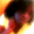 A pixelated image shows a dark circular shape surrounded by warm orange and yellow tones with red accents, appearing as an abstract or stylized representation.