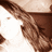 A pixelated image of a person with long brown hair and a white face, partially obscured by a brown horizontal bar, with a gray rectangular overlay on the right side.
