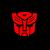Static pixelated red icon of a stylized Transformer face with dark green eyes and black accents on a dark background.