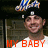 A pixelated image shows a person with short hair wearing a white shirt, with red text reading 'MY BABY' at the bottom and a blue-and-white object above the head.