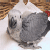 Animated sequence of a gray parrot with white head and red cheek patches on woven background, showing text changes from 'how' to 'kute' and heart icon transitions.