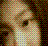 Pixelated static image of a person with light skin tone, short brown hair, and closed eyes wearing a white top against a dark green background.