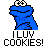 Pixelated blue Sesame Street character with white eyes and black pupils, standing next to red text 'Instant Icons' and '.com', below which is large black pixelated text reading 'I LUV COOKIES!'