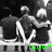Three pixelated figures in dark clothing stand on a platform with green text reading "love" at the bottom.
