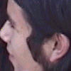 Yellow text characters and symbols on black background with small profile photo in top-left corner, including 'k@zueIaS' layout and registered trademark symbol.