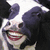 Pixelated image of a cow with a human face, red lips, and a black-and-white patterned body, next to bold text on a black background.