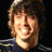 A 48x48 pixel buddy icon split into two frames showing a person on the left and green text on a dark background on the right, with visible pixelation and dithering effects.