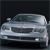 Static pixelated image of a silver sedan with dark-tinted windows, front grille, headlights, and side mirrors visible against a dark background.