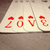 Red pixelated text 'love' with small red crown symbols above each letter on a light background, displayed in four